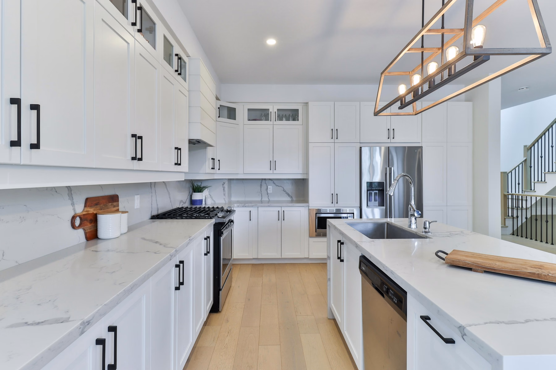 White shaker kitchen with island and marble-look countertop