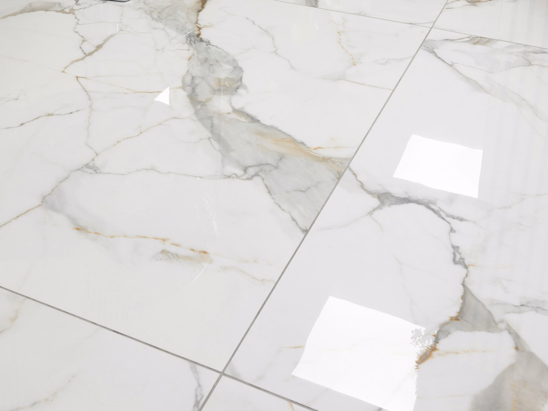 Large-format marble-look porcelain floor tiles with fine veining