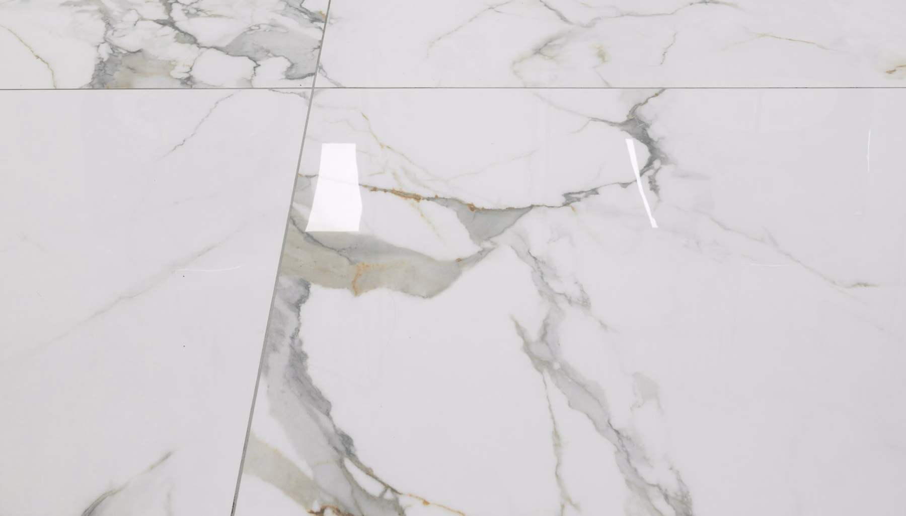 Polished marble-look floor tiles with soft grey and gold veining