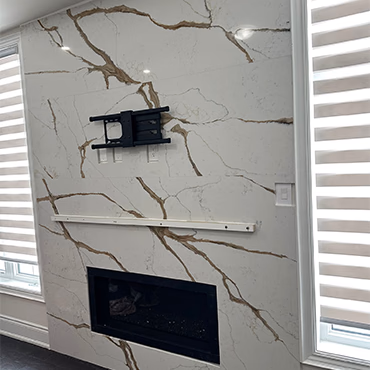 Veined stone fireplace wall with a linear fireplace opening
