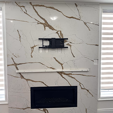 Floor-to-ceiling stone fireplace surround, close view