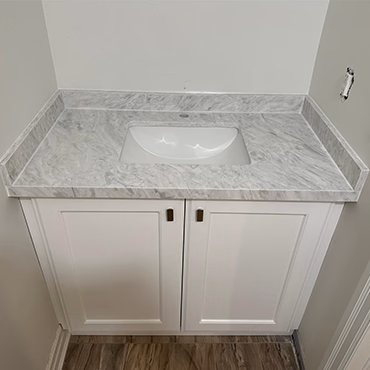 Veined stone vanity top with a white undermount sink and shaker vanity